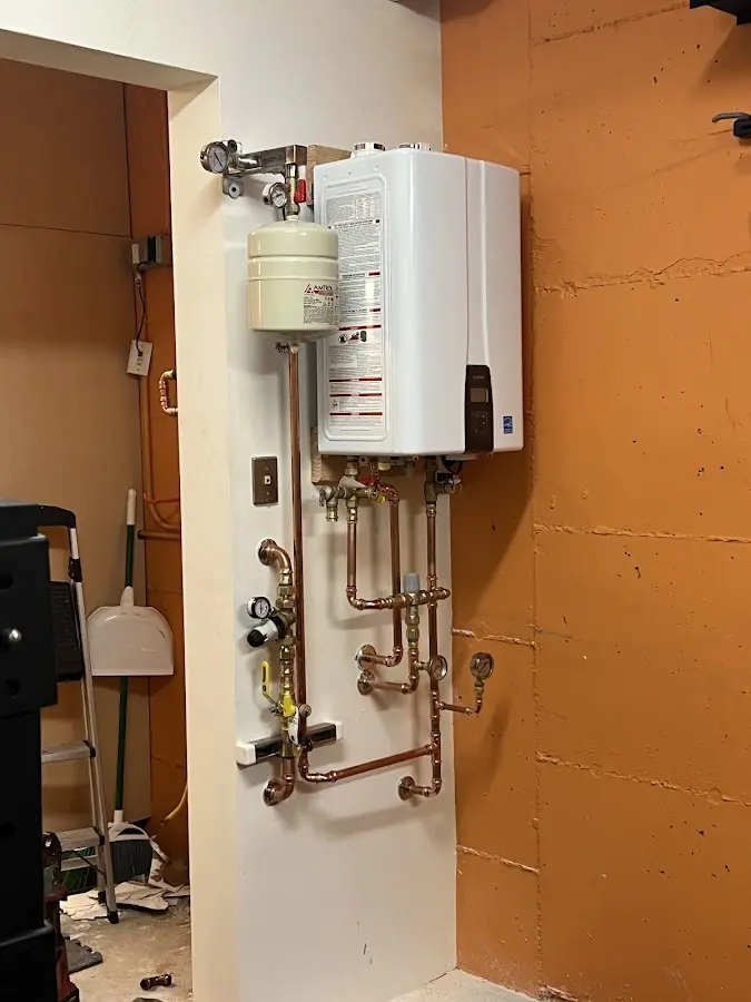 Plumbing technician inspecting water heater connections in Fountain Inn